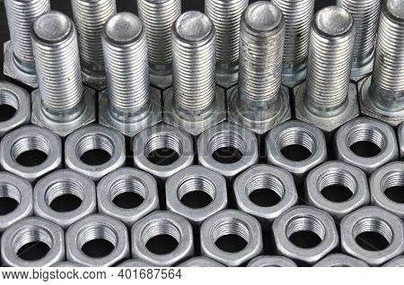 Metal Bolts And Nuts In A Row Background. Steel Bolts And Nuts Pattern. Set Of Nuts And Bolts.
