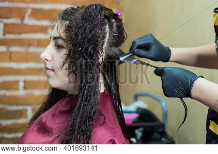 Brunette Girl Does Keratin Hair Straightening On Her Curly Hair. Keratin Hair Straightening In The S