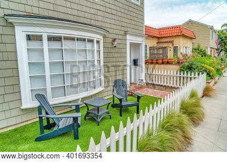 Front Yard Of House With Furniture Against Curved Bay Window In Long Beach Ca