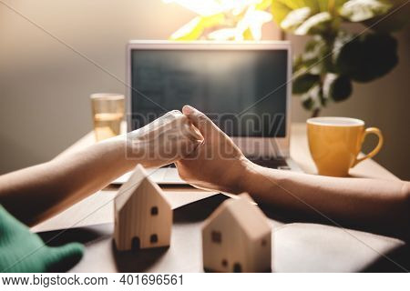 Buying A New House Concept. Couple Holding Hand And Seeing A Plan Design On Computer Laptop. Dream H