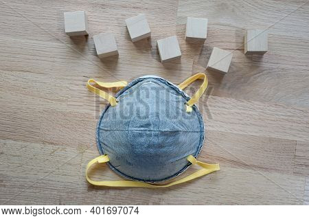 N95 Mask On The Wooden Table With Group Of Wooden Cube For Input Wording,helps Prevent Corona Virus 