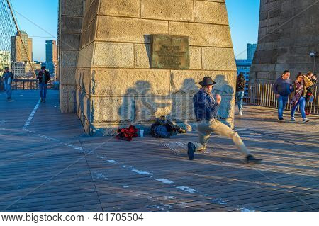 New York, Usa - March 9, 2020: Street Dancer Man Performs On The Brooklyn Bridge In Afternoon Light,