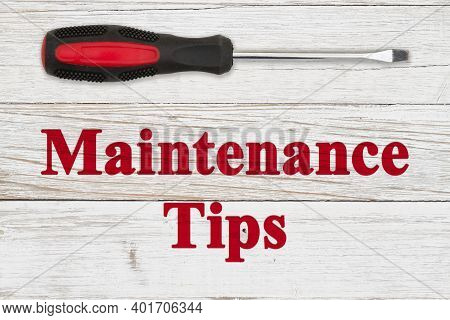 Maintenance Tips Message With Red And Black Screwdriver On Distressed Whitewash Wood