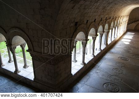 Girona Cathedral, Spain. Historic Cloisters. High Angle Shot With Dramatic Light And Shade As Sunshi