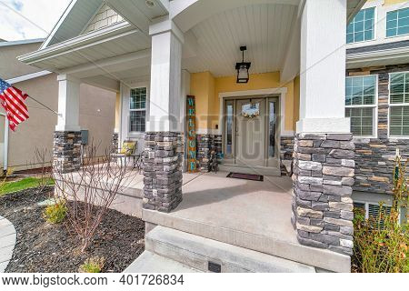 Home With Arched Entrance To The Open Porch And Front Door With Sidelights