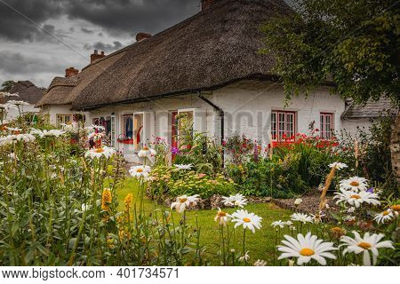 Adare, Ireland. Thatched Cottage In The Picturesque Village Of Adare, Co. Limerick Full Of Flowers I