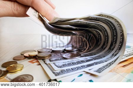 Man Holding A Stack Of American Dollar Bills. Detail Of A Macro Shot. Money Market, Finance, Currenc