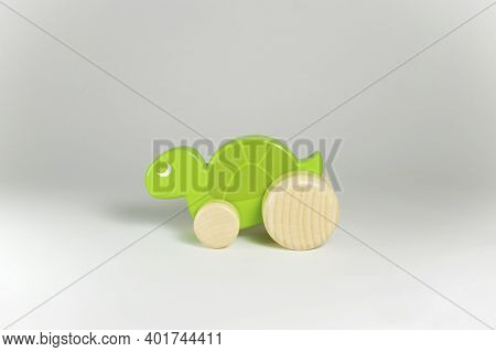 Wooden Toy Turtle On A Gray Background.
Side View. Selective Focus.