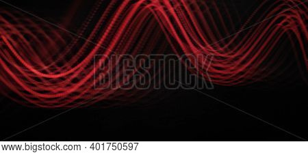 Neon Red Light Wave Pattern Abstract Isolated And Flowing Through The Black Background