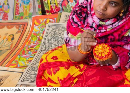 Kolkata, West Bengal, India - 31st December 2018 : Young Bengali Female Artist Painting Pattachitra 