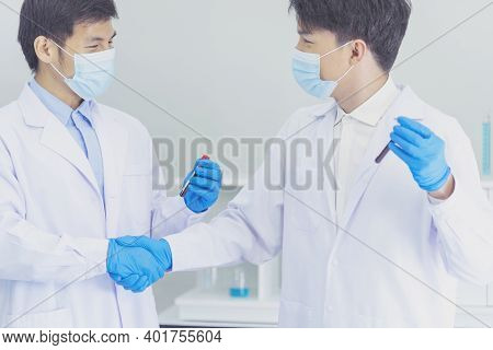Two Asian Scientist Team Reserch Chemistry Science Tube Experiment Biotech Antibody Sample In Labora