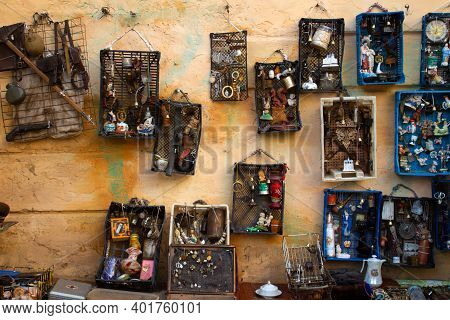 Aged Wall With Different Antiques On Flea Market Or Festival - Vintage Silver Cultery - Spoons, Knif