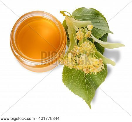 Jar Of Linden Honey And Lime Flowers Around A Jar Isolated On White Background. Top View.