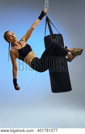 Fit Beautiful Woman With Boxing Bandages And Punching Bag On Studio Background. Full Lenth