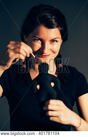 Malefic Young Woman After Breakup Using A Textile Doll As A Voodoo Doll