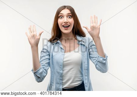 Portrait Of Surprised Young Female With Long Chestnut Hair, Dressed In Casual Clothes, Smiling Happi