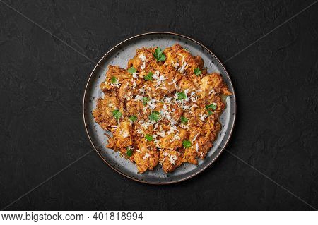 Mangalorean Chicken Sukka On Black Plate On Dark Slate Table Top. Indian Cuisine Coconut Curry Dish.