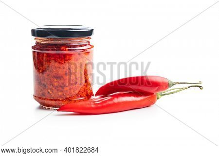 Red hot chili paste and chili peppers isolated on white background.