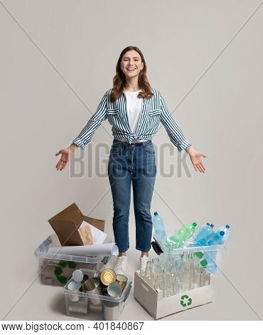 Waste Sorting. Happy Woman Standing Among Different Kind Of Sorted Garbage, Showing Boxes And Contai