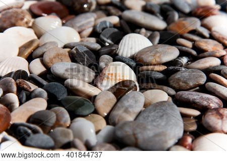 Background From Multi-colored Stones. Texture Of Sea Stones. Red And Blue Pebbles. Stone Beach. Mine