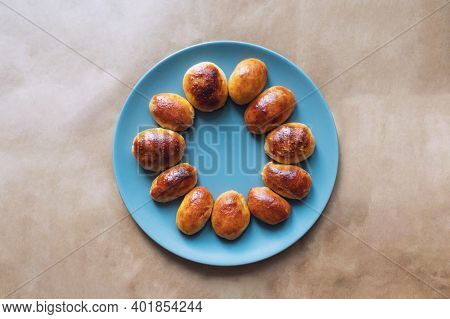 Meat Pies On A Blue Plate With Brown Background