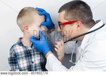 An Ophthalmologist Examines A Boy Who Complains Of Burning And Pain In His Eyes. Eye Fatigue From A