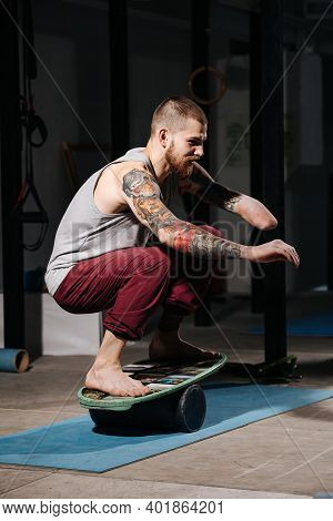 Coordinated Young Disabled Armless Man Balancing On A Roller Board Trainer