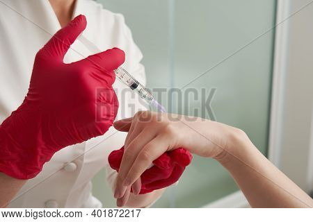 Woman Getting Rejuvenating Filler Injections In Her Hand. Beautician Injecting Filler In Hand Skin O
