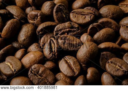Coffee Beans Background. Fried Coffee On Grunge Wooden Background.