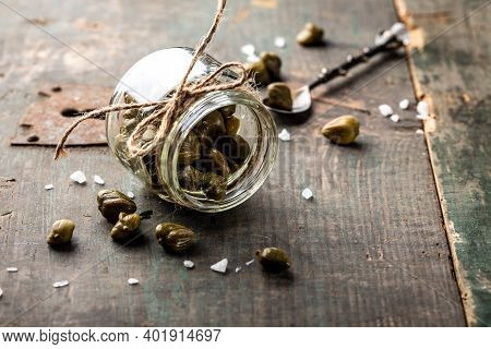 Pickled Capers On A Dark Wooden Background. Edible Flower Buds Of Capparis Spinosa, Caper Bush Or Fl