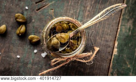 Pickled Capers On A Dark Wooden Background. Edible Flower Buds Of Capparis Spinosa, Caper Bush Or Fl
