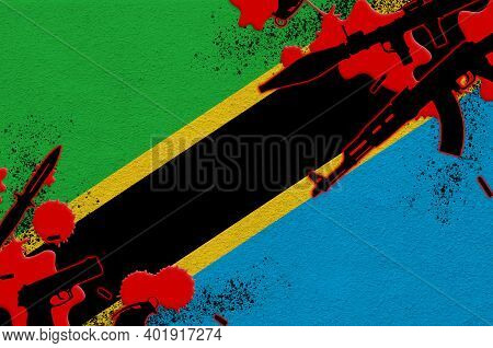 Tanzania Flag And Various Weapons In Red Blood. Concept For Terror Attack And Military Operations Wi