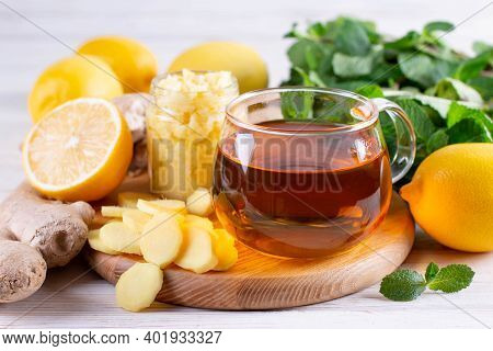 A Glass Cup Of Fresh Herbal Tea With Lemon, Honey, Ginger And Green Mint Leaves. Fall Immune System 