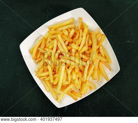 Flat Lay Or Top View Of A Plate Of French Fres On A Dark Green Textured Background