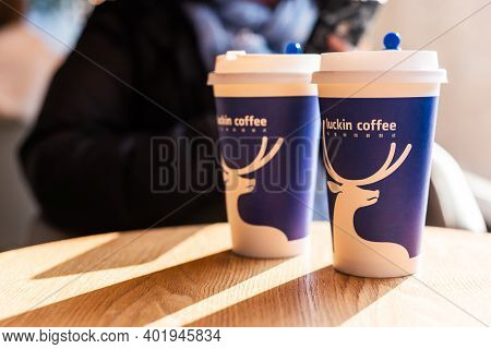 Chengdu, Sichuan Province, China - Dec 31, 2020: Two Cups Of Coffee On A Wooden Table In Luckin Coff