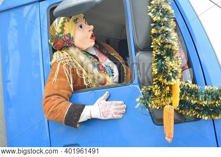Man In A Festive Costume And Mask In The Car