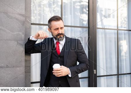 Selective Focus At Face. Adult Caucasian Business Man With Beard, Dress In Formal Suit Standing In C