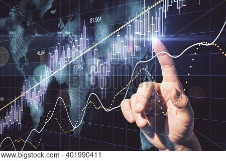 Hand Using Candlestick Chart With Digital World Map Hologram. Global And Invest Concept.
