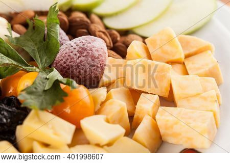 A Cheese Tray With Fruit Food Party.