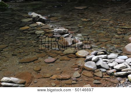Mountain river with blue clean water and stones at Catskils mountains upstate NY