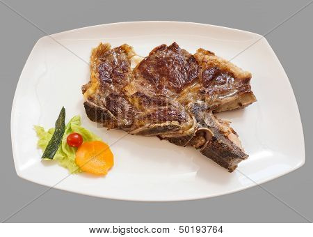 grilled t-bone steak and vegetables , close up