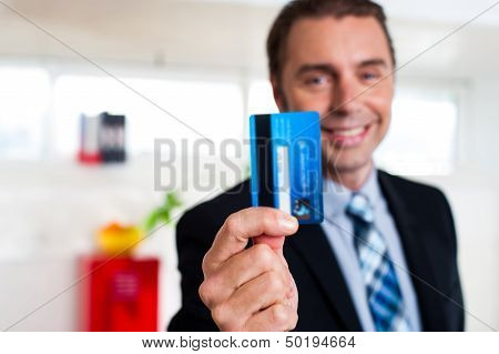 Cheerful Businessman Holding Up His Credit Card