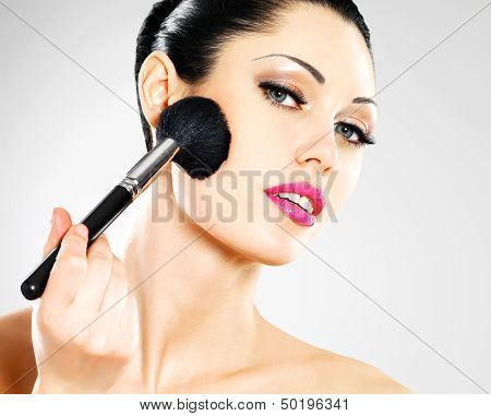 Beautiful Woman Applying Blusher On Face