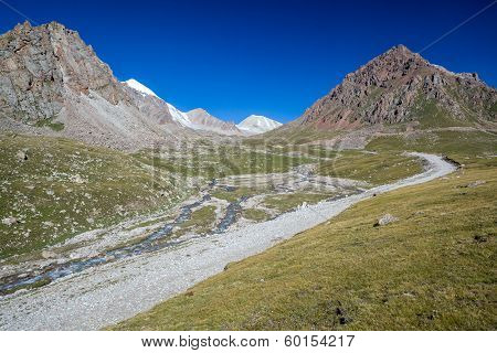Mountain road along river. Tien Shan