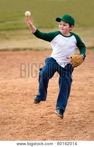 Boy throws baseball during practice