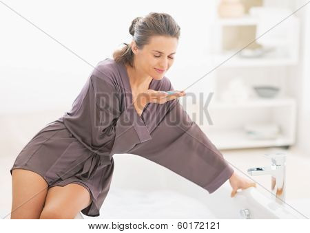 Happy Young Woman Smelling Bath Salt