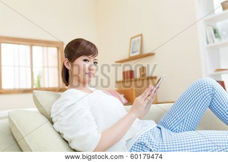 Beautiful asian woman relaxing in the room 