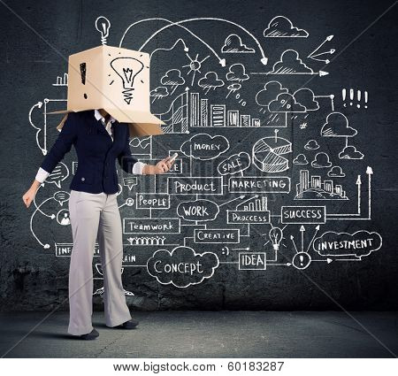 Businesswoman using mobile phone wearing carton box on head