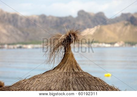 Cane beach umbrella in Pollenca Port. Majorca Spain
