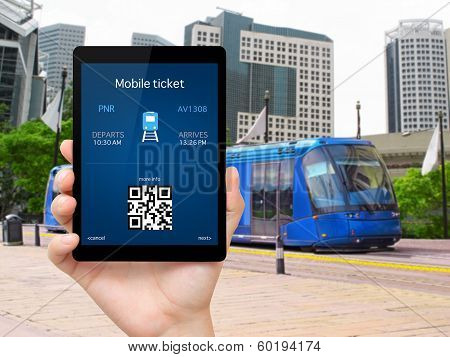 Man Hand Holding a Tablet With A Mobile Wallet And Train Ticket Against The Train